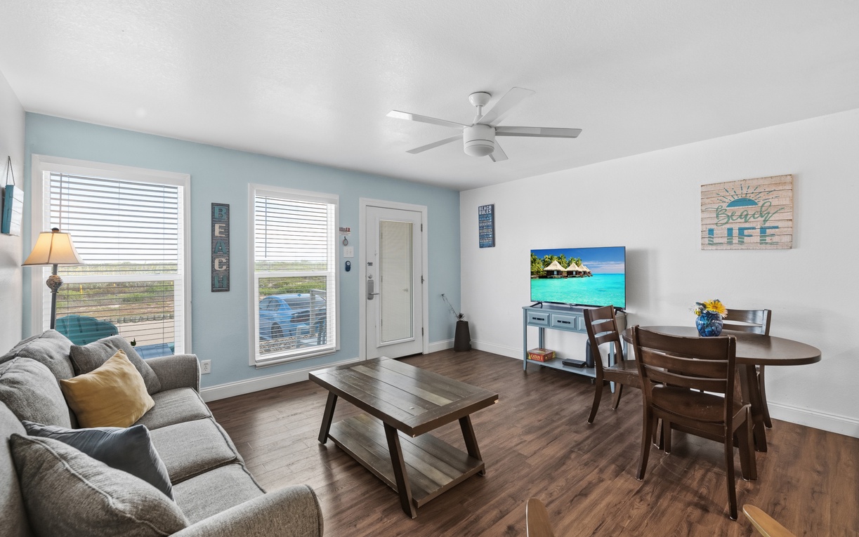 Step into your bright, open living space where coastal breezes flow through and soft blue walls welcome you home. Windows frame genuine water views while you relax, dine, or unwind.