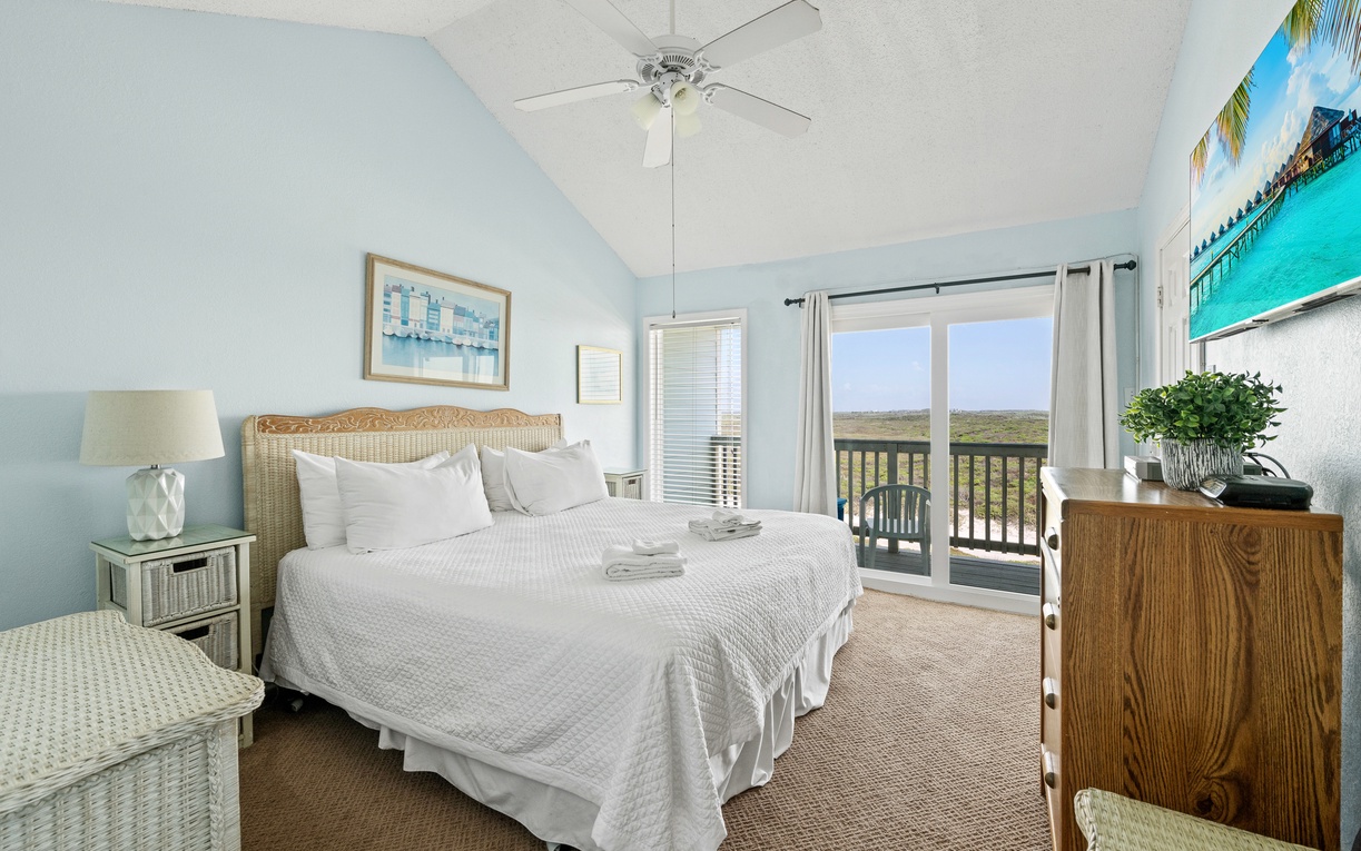 Wake up to natural light in the spacious primary bedroom, complete with a king bed and direct access to the private balcony for enjoying the coastal breeze.