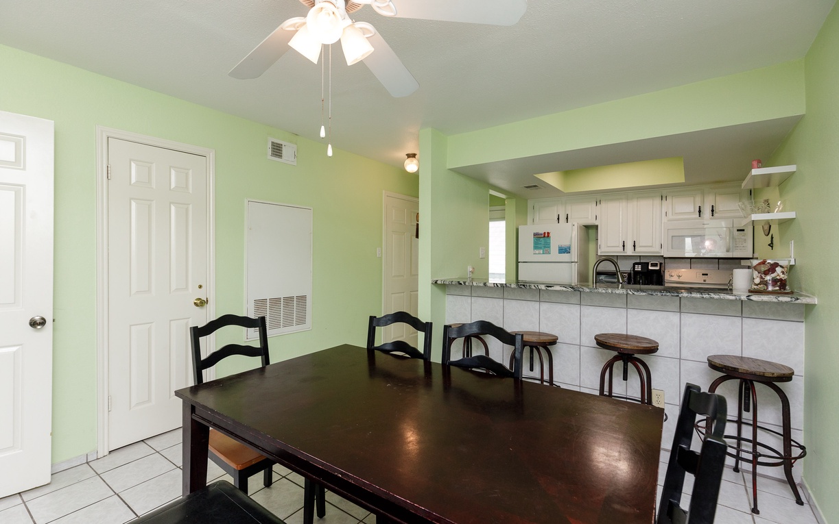 Gather around your spacious dining table while meals are prepared in the bright, open kitchen - perfect for group conversations and shared moments.