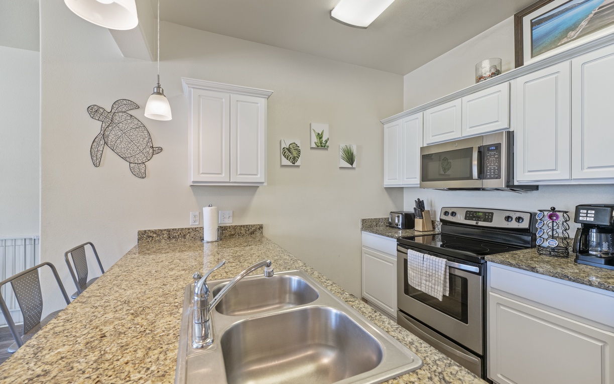 Gather around this bright kitchen where white cabinets and granite counters invite you to cook memorable meals together.