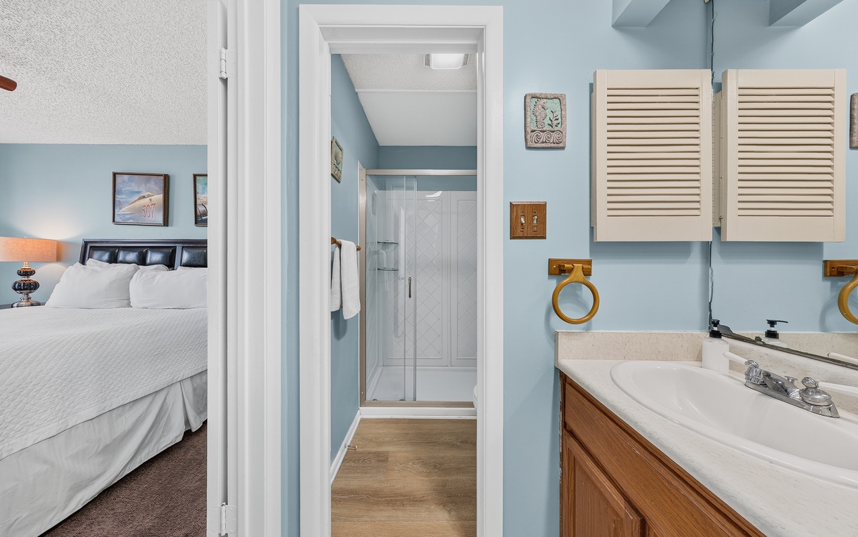 Freshen up in your private en-suite bathroom with a walk-in shower, then sink into the plush bed just steps away. Coastal-blue tones and nautical touches make this suite feel like your own seaside retreat.