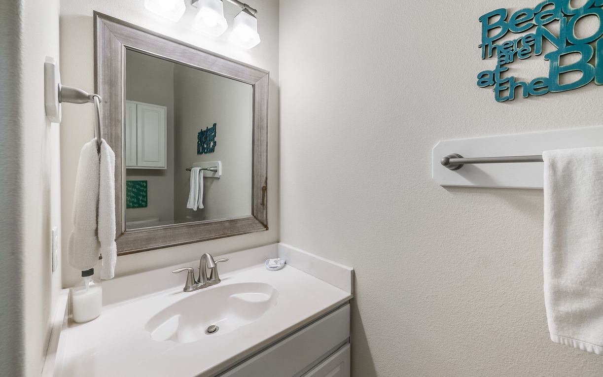Step into your clean, bright bathroom featuring fresh white vanity, elegant mirror, and soft towels ready for your comfort.