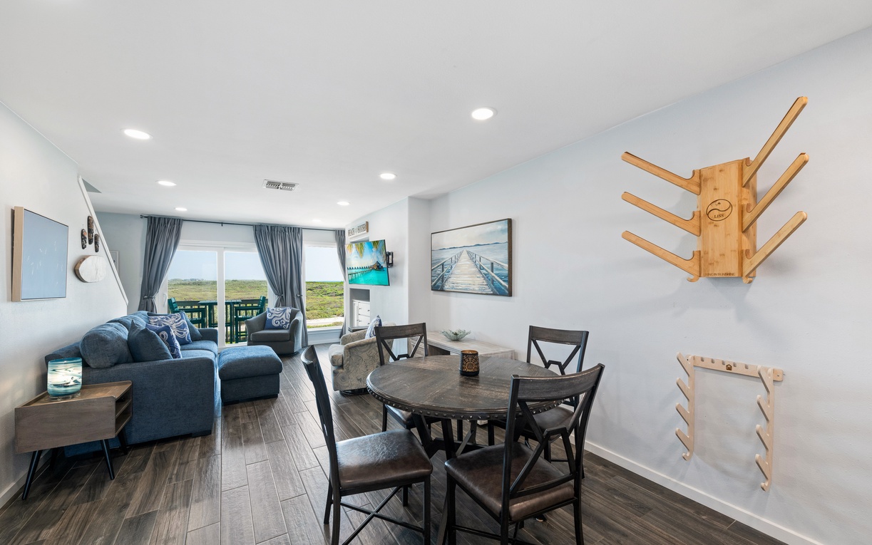 Sink into plush seating with dune views stretching beyond your windows. This open, sunlit space blends dining and relaxation, inviting you to unwind after beach days.