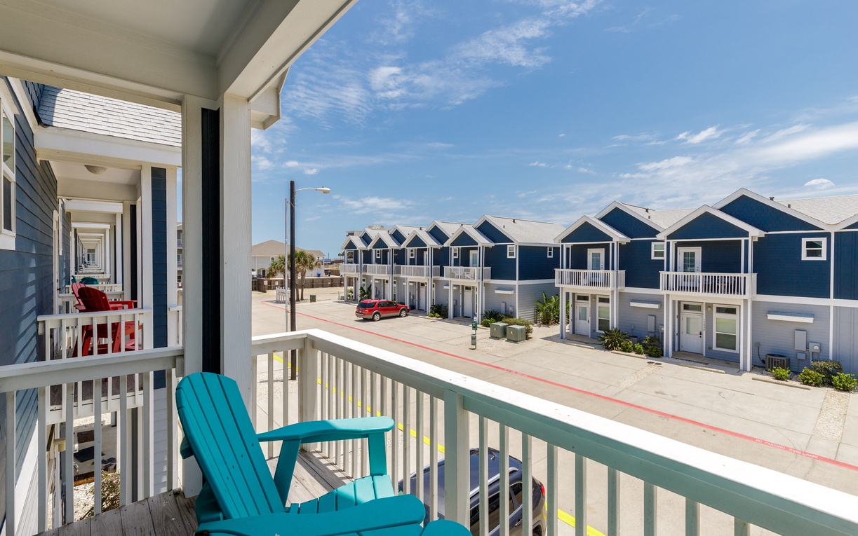 Step out onto your private balcony and sink into the turquoise Adirondack chair, where coastal views and gentle breezes create the perfect spot for morning coffee.