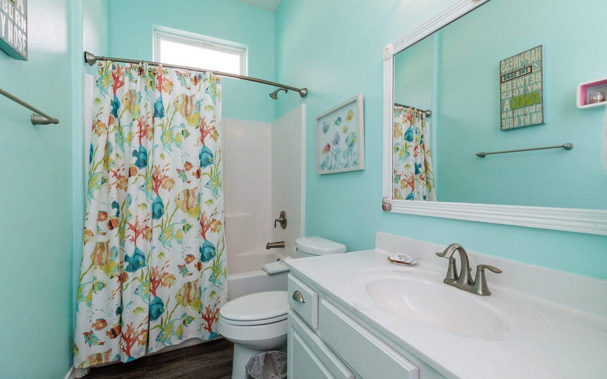 Refresh in your cheerful aqua bathroom with tropical florals and coastal charm.