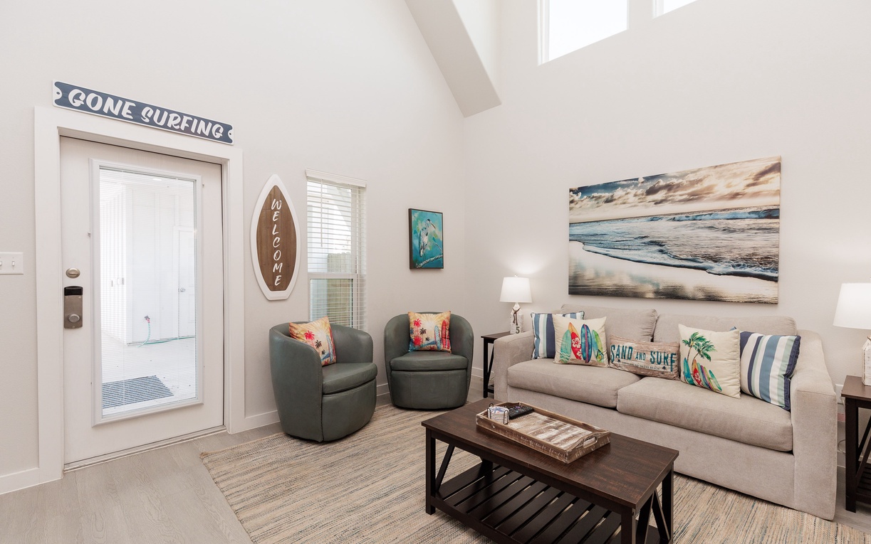 Unwind in your coastal-themed living room where beach vibes meet comfort—perfect for relaxing after your adventures.