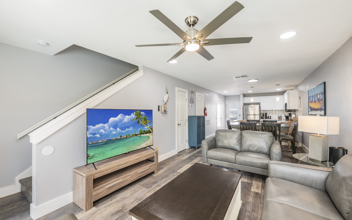 Relax in your modern living space with plush gray seating and open kitchen design for seamless entertaining.