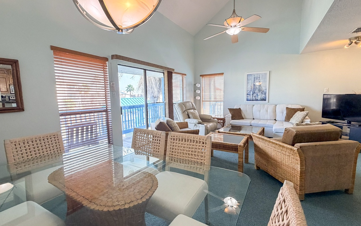 Relax in your bright, airy living space with comfortable seating and large windows overlooking the balcony, perfect for unwinding after beach days.
