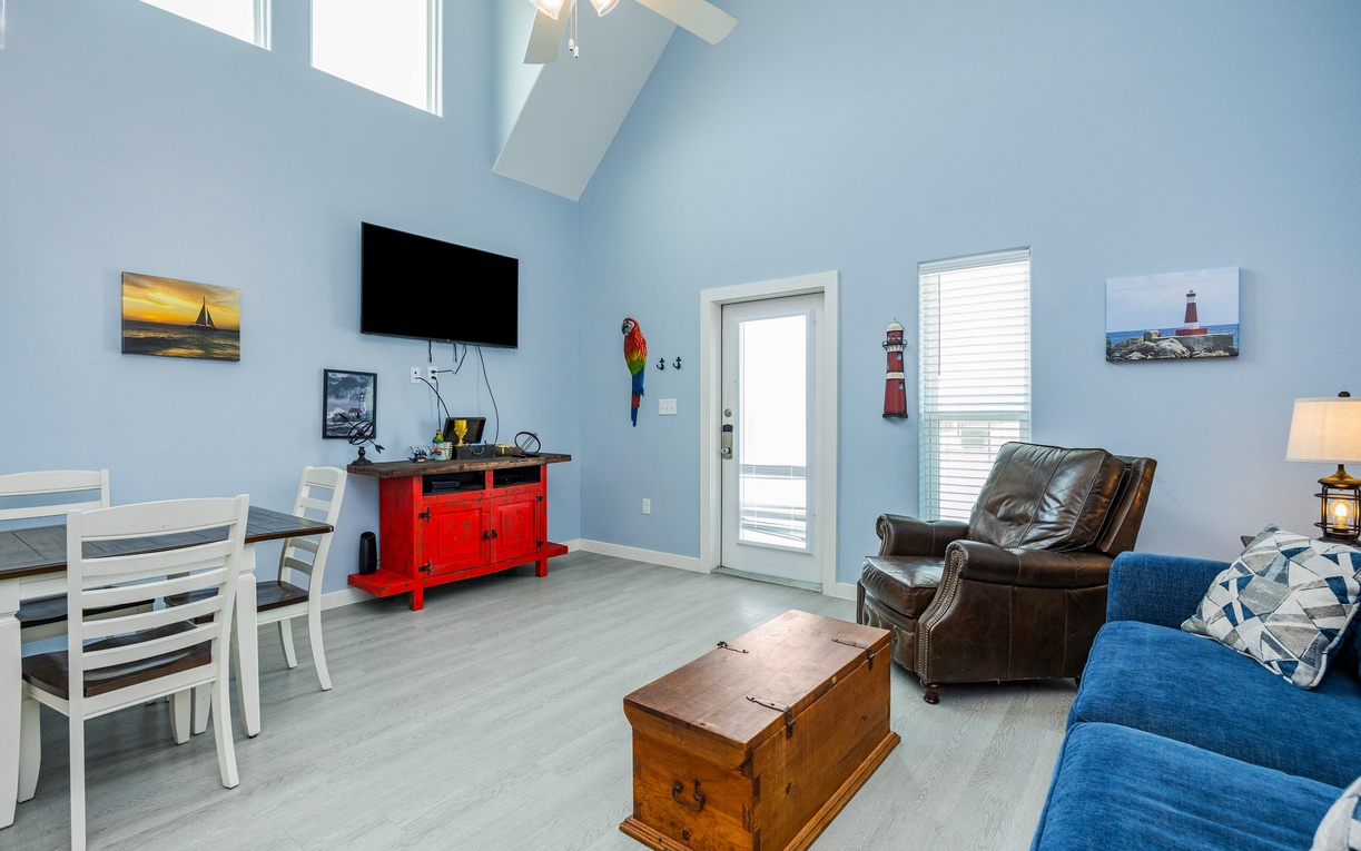 Relax in your bright living space with soaring ceilings, cozy seating, and nautical charm that makes you feel right at home by the sea.