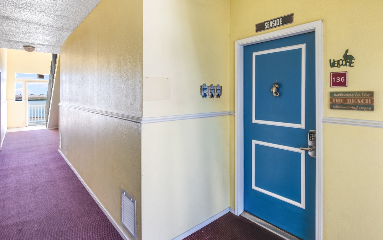 Welcome to your seaside retreat! Your cheerful yellow hallway leads to room 136, where beach adventures await just steps away.