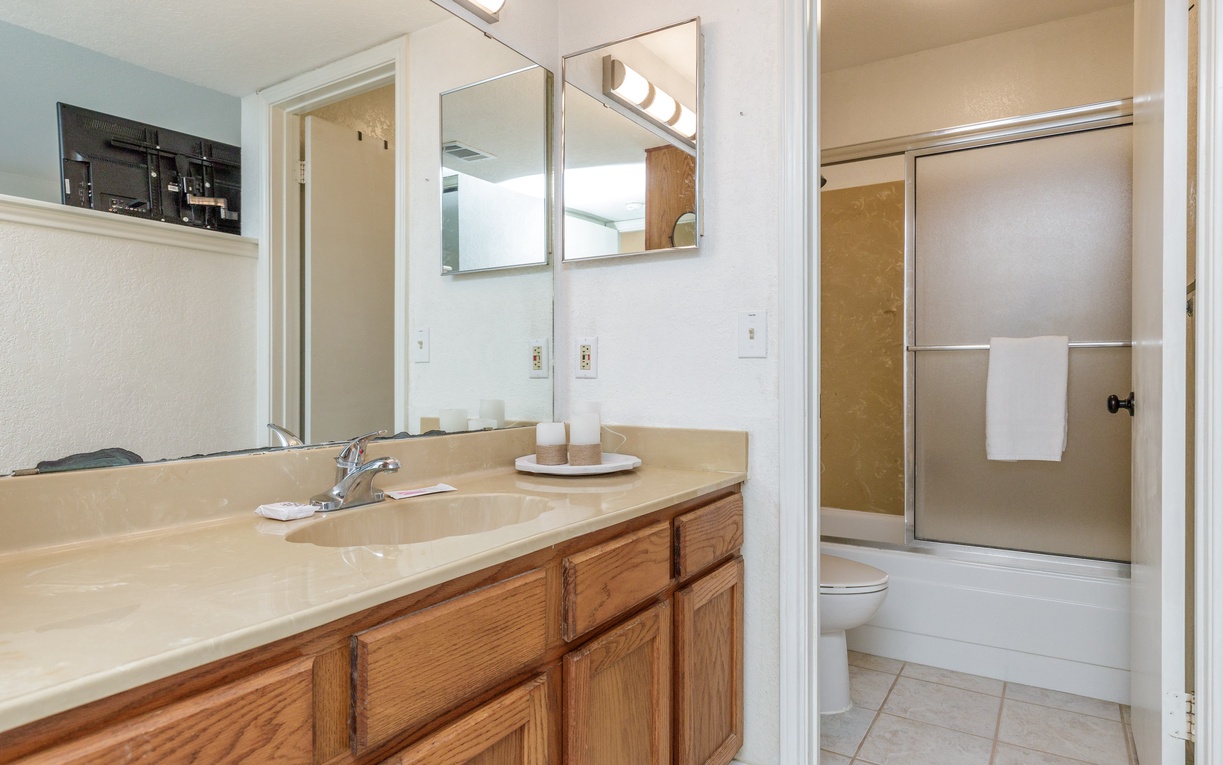 Refresh in your spacious bathroom with dual sinks, ample storage, and a convenient shower-tub combo.