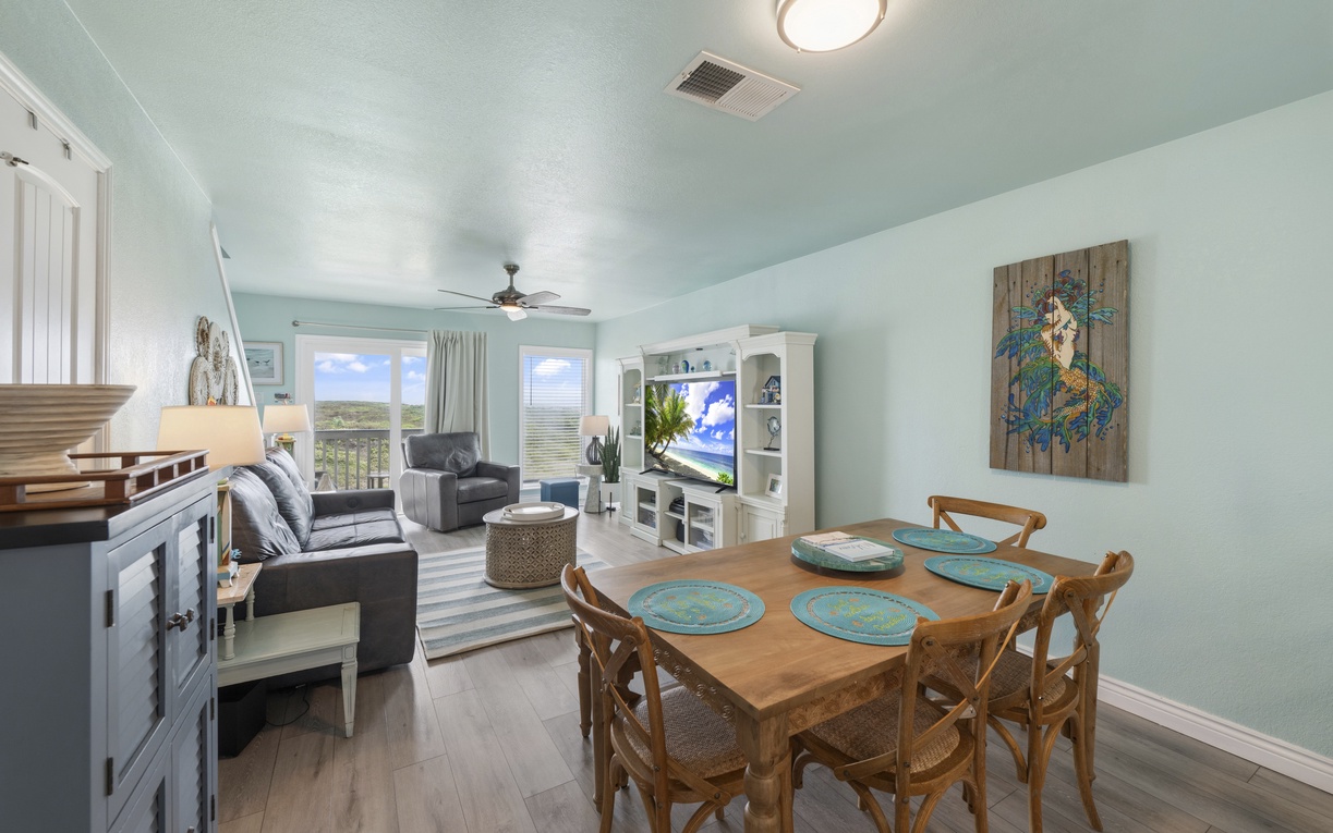 Bright, open-concept coastal living with comfortable seating, dining space, and dune views just beyond the balcony.