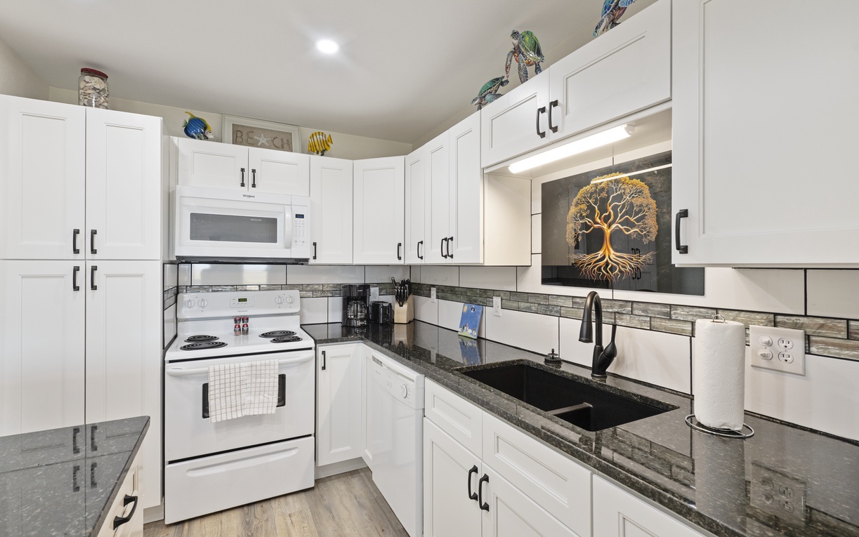 Your fully equipped kitchen features crisp white cabinets, granite counters, and modern appliances for memorable meal prep.