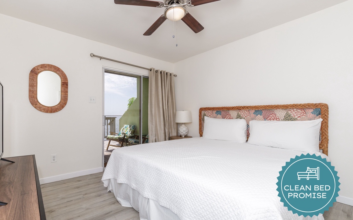 Drift off in this serene bedroom with crisp linens, tropical touches, and your own peaceful balcony retreat.