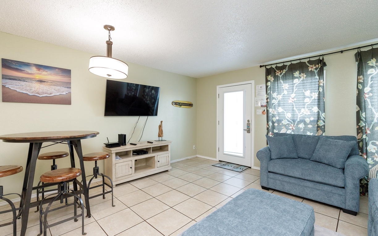 Unwind in your cozy living space with coastal charm, featuring comfortable seating and modern amenities for perfect relaxation.