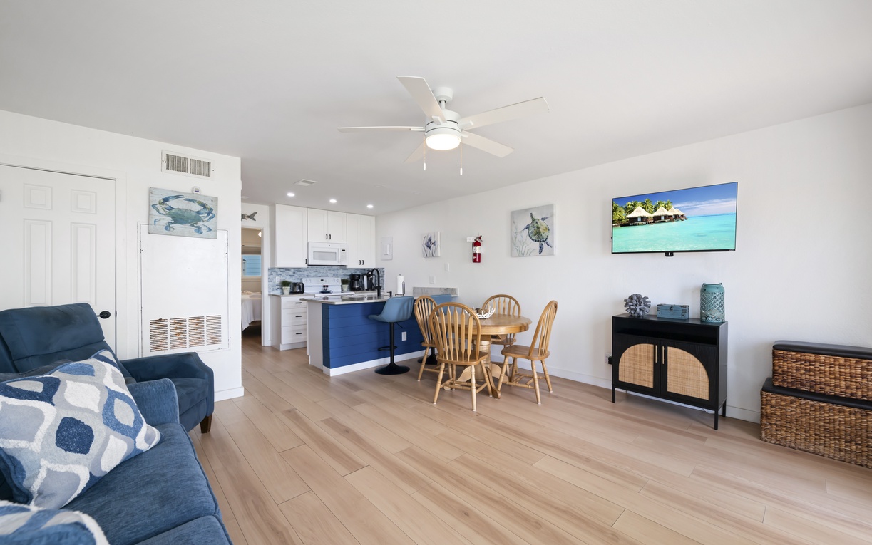 Step into your bright, airy retreat with coastal charm. Relax in the open living space, enjoy meals at the dining table, and take in the tropical vibes throughout this welcoming home.