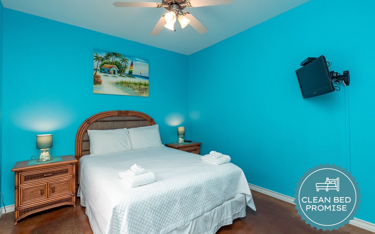 Drift off to peaceful sleep in your bright coastal bedroom, with crisp white linens and tropical artwork setting the perfect vacation mood.