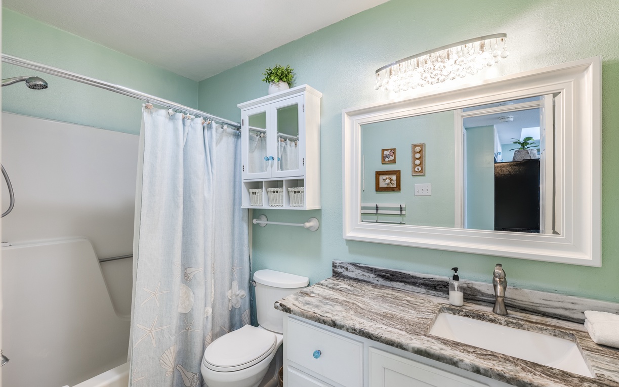 Refresh in your private bathroom featuring elegant marble countertops, soothing mint walls, and a spacious shower - your peaceful retreat awaits.