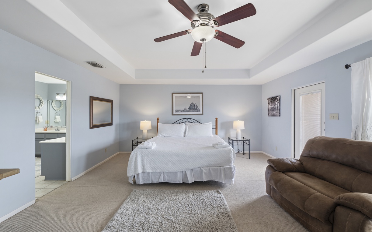 Relax in your plush king bed, cozy seating area, and private balcony access.