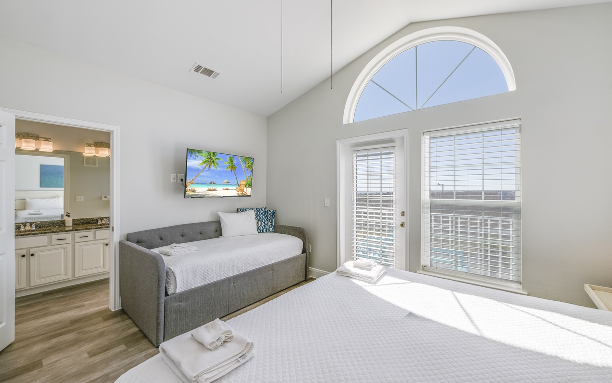 Relax in your bright bedroom with daybed, TV entertainment, and private bathroom access—all bathed in natural light.