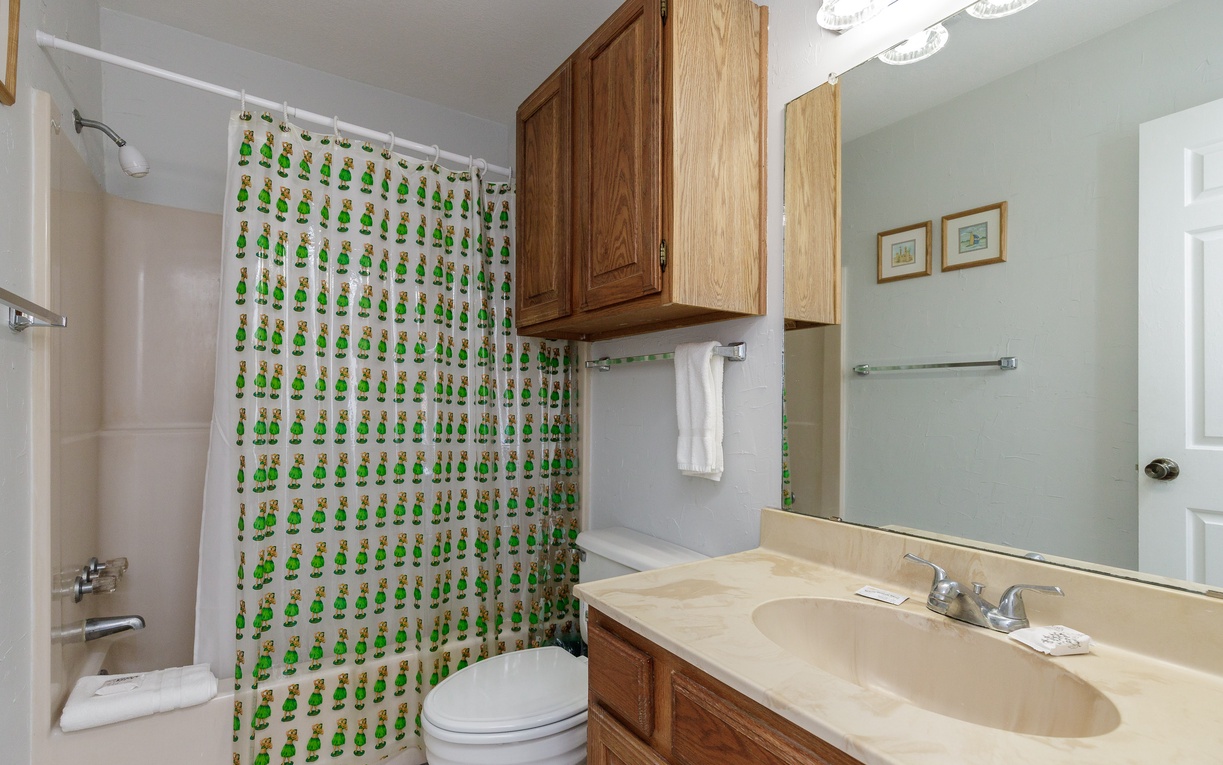 Your primary ensuite bathroom features a full tub-shower combo, vanity sink, and charming frog-themed curtain that adds personality to your space.