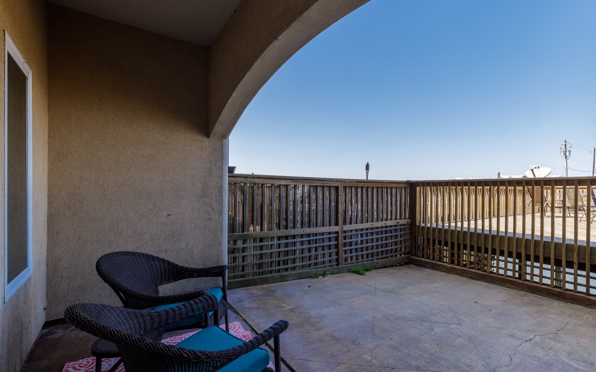 Relax on your private terrace with comfortable outdoor seating and open sky views above.