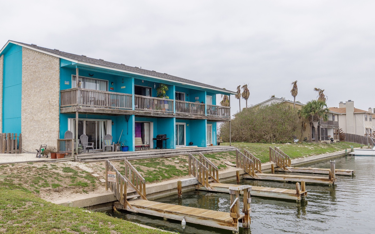 Waterfront property featuring direct access to private fishing docks and boat slips along the canal.