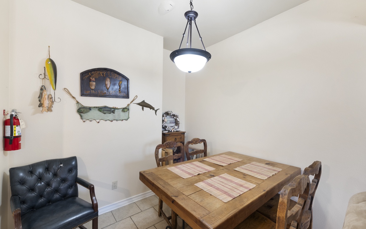 Gather around this rustic dining table where your mornings start with coffee and conversation. The fishing-themed décor adds character and charm to your shared meals together.