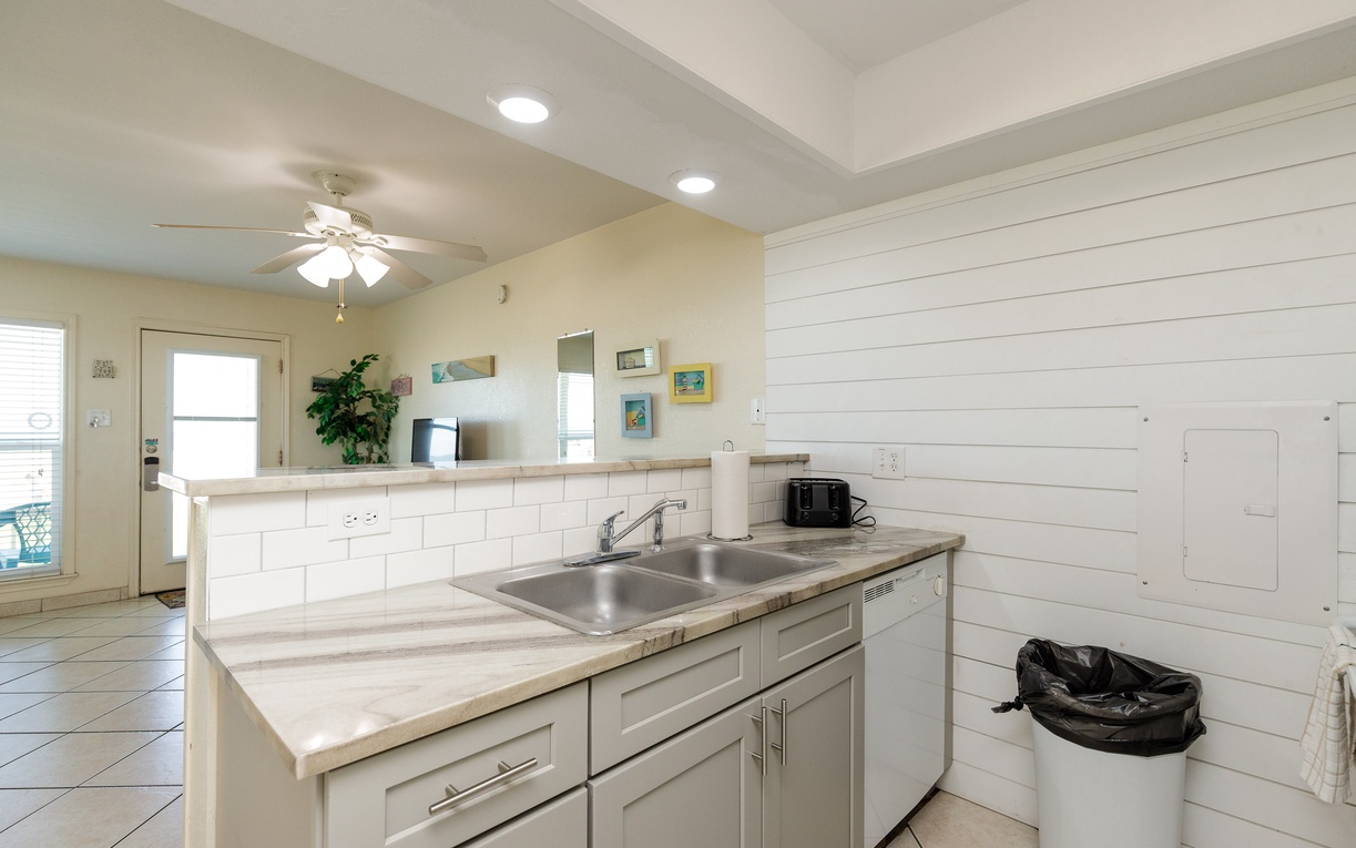 Your bright kitchen features modern appliances, subway tile backsplash, and charming shiplap accent wall for effortless meal preparation.