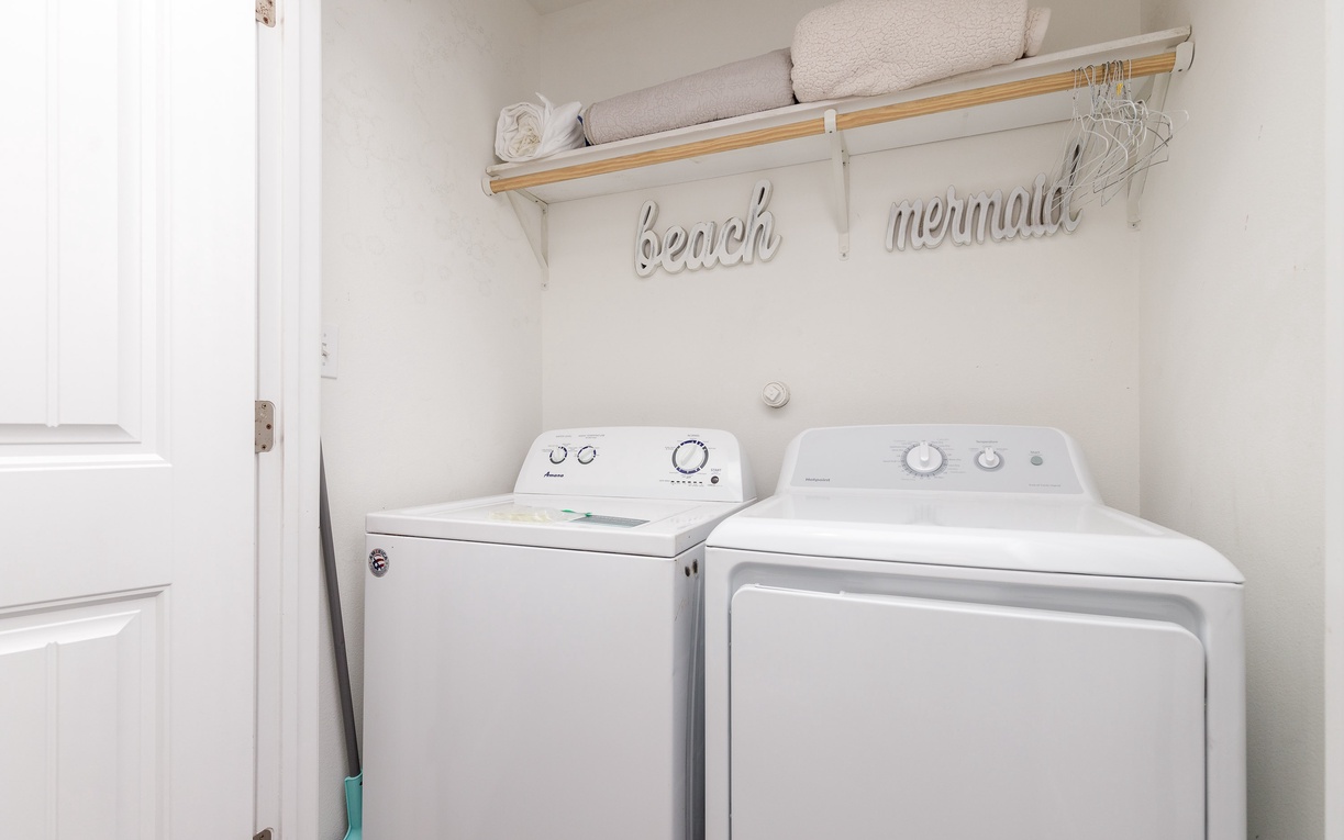 Your private laundry room features a full-size washer and dryer, plus fresh towels and charming coastal décor for ultimate convenience.