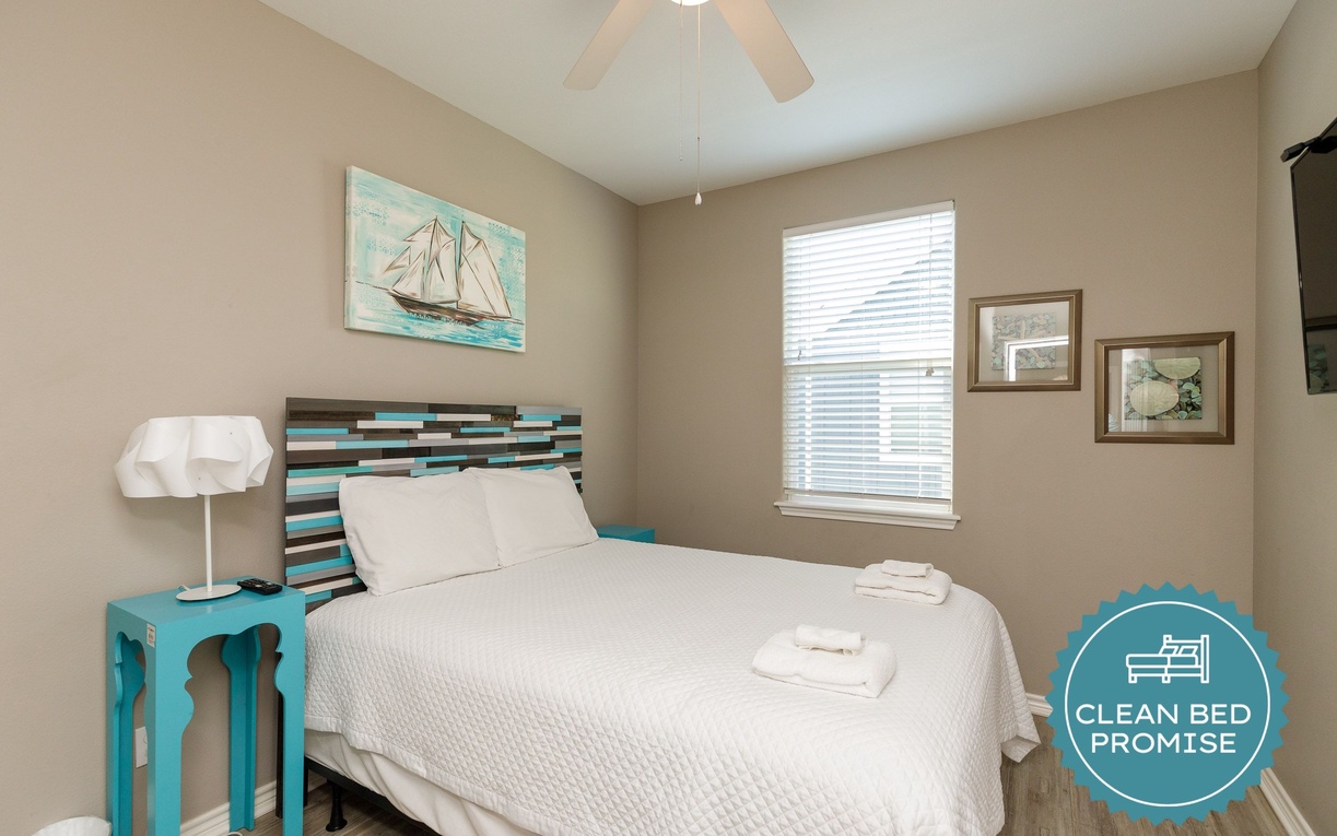 Rest comfortably in your cozy bedroom featuring fresh linens, nautical decor, and gentle natural light for peaceful nights.
