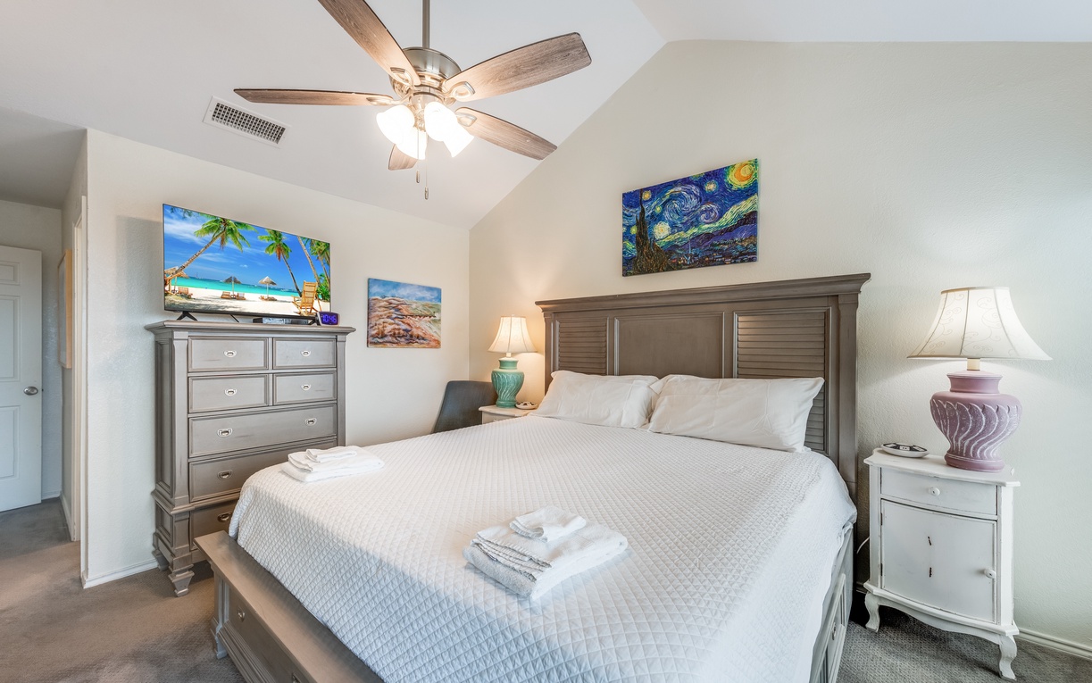 Drift off in your serene bedroom sanctuary, where coastal artwork and soft linens create the perfect retreat.