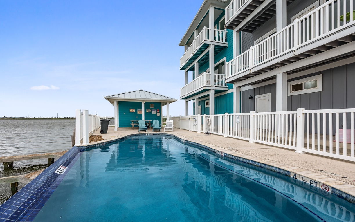 Dive into your private pool oasis with stunning waterfront views and vibrant turquoise waters beckoning you to relax.