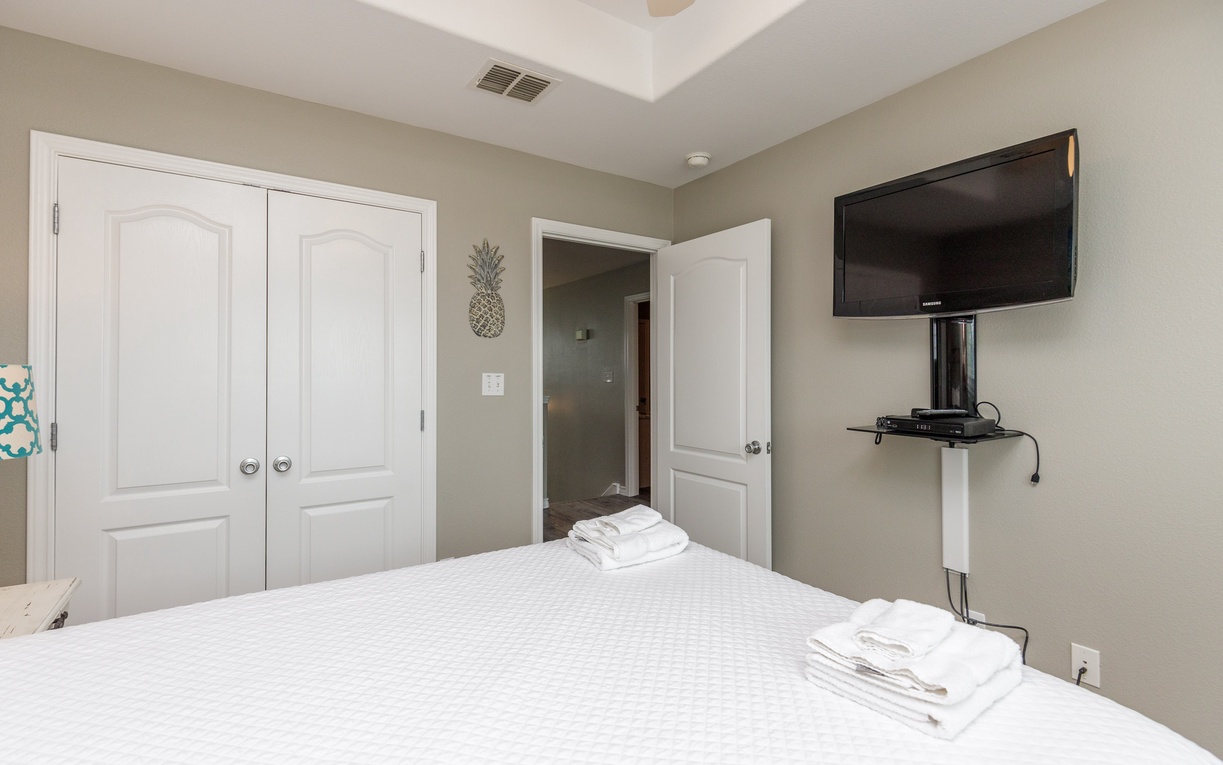 Relax in your peaceful bedroom with fresh linens, flat-screen TV, and private bathroom access for ultimate comfort.