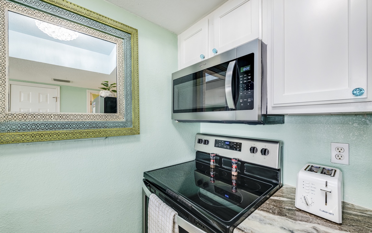 Your fully equipped kitchen features modern appliances including microwave, stove, and toaster for convenient meal preparation during your stay.