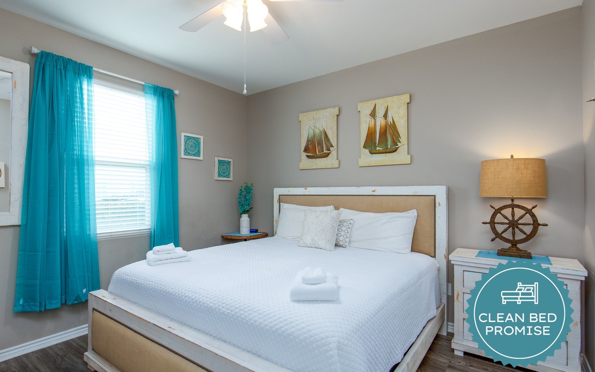 Drift off in your coastal-themed bedroom with crisp white bedding, nautical artwork, and turquoise touches creating a serene seaside escape.