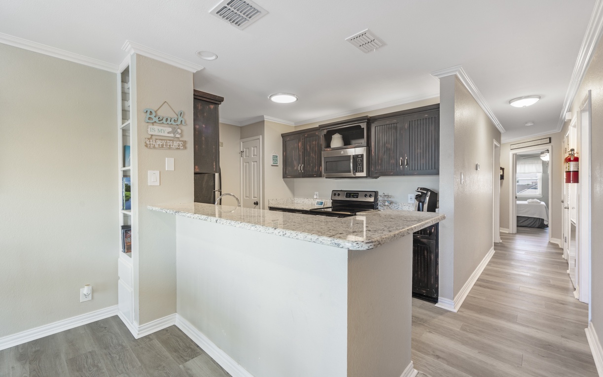 Your fully equipped kitchen features granite counters and modern appliances, perfect for preparing meals during your stay.