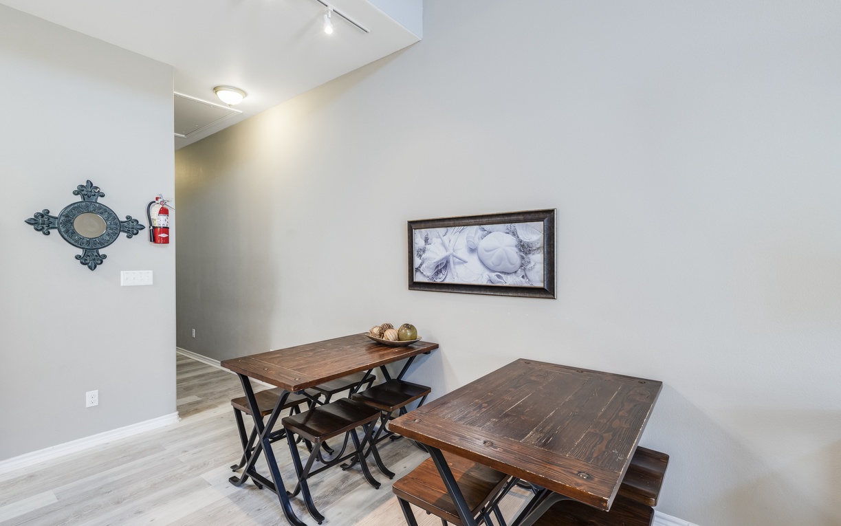 Gather around rustic dining tables where shared meals become cherished memories in this warm, welcoming space.