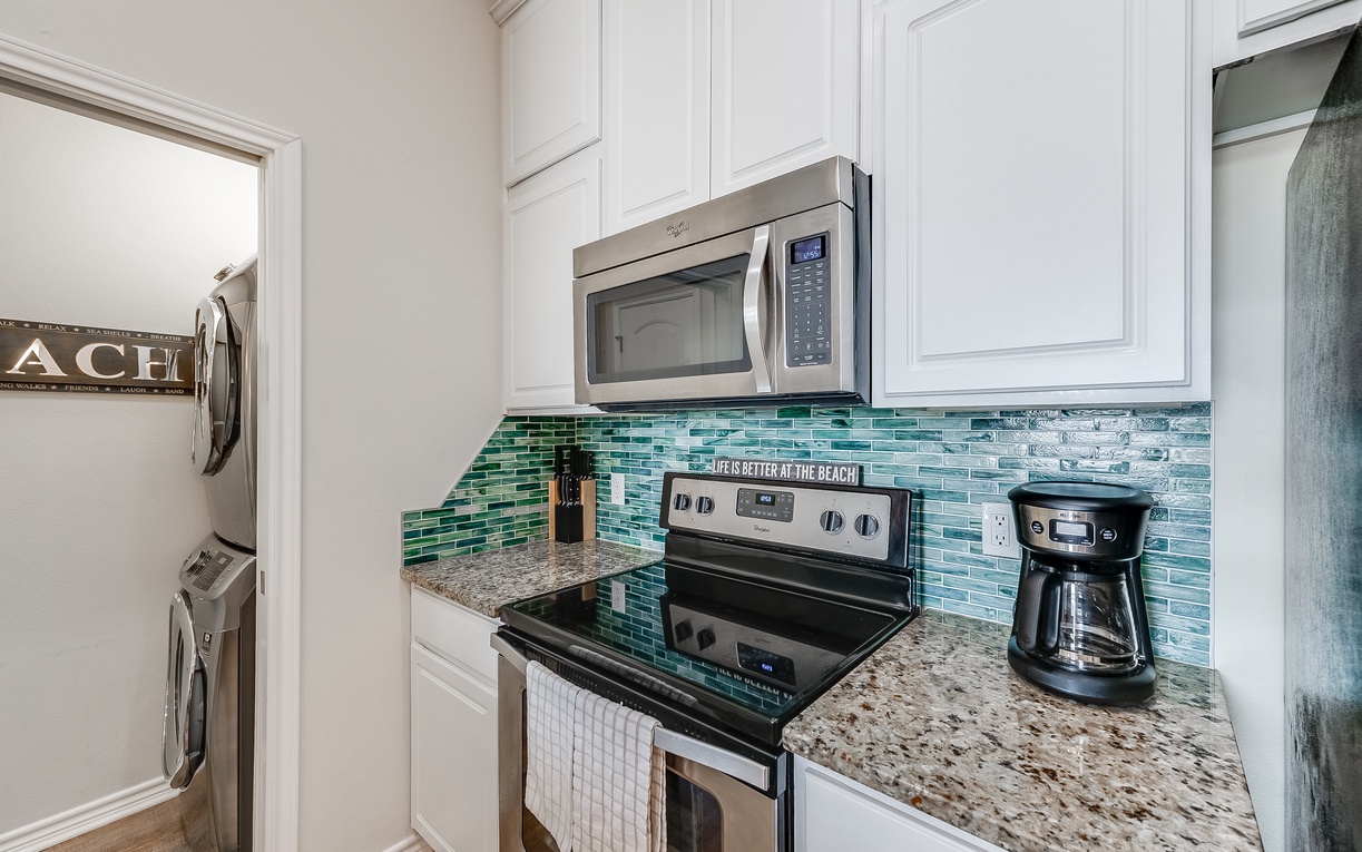 Your fully equipped kitchen features granite counters, ocean-inspired backsplash, and everything you need to create memorable meals during your stay.