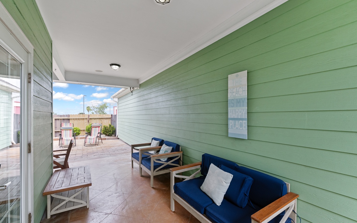 Your private covered terrace invites relaxation with nautical-blue cushioned seating and charming coastal decor in refreshing mint green.