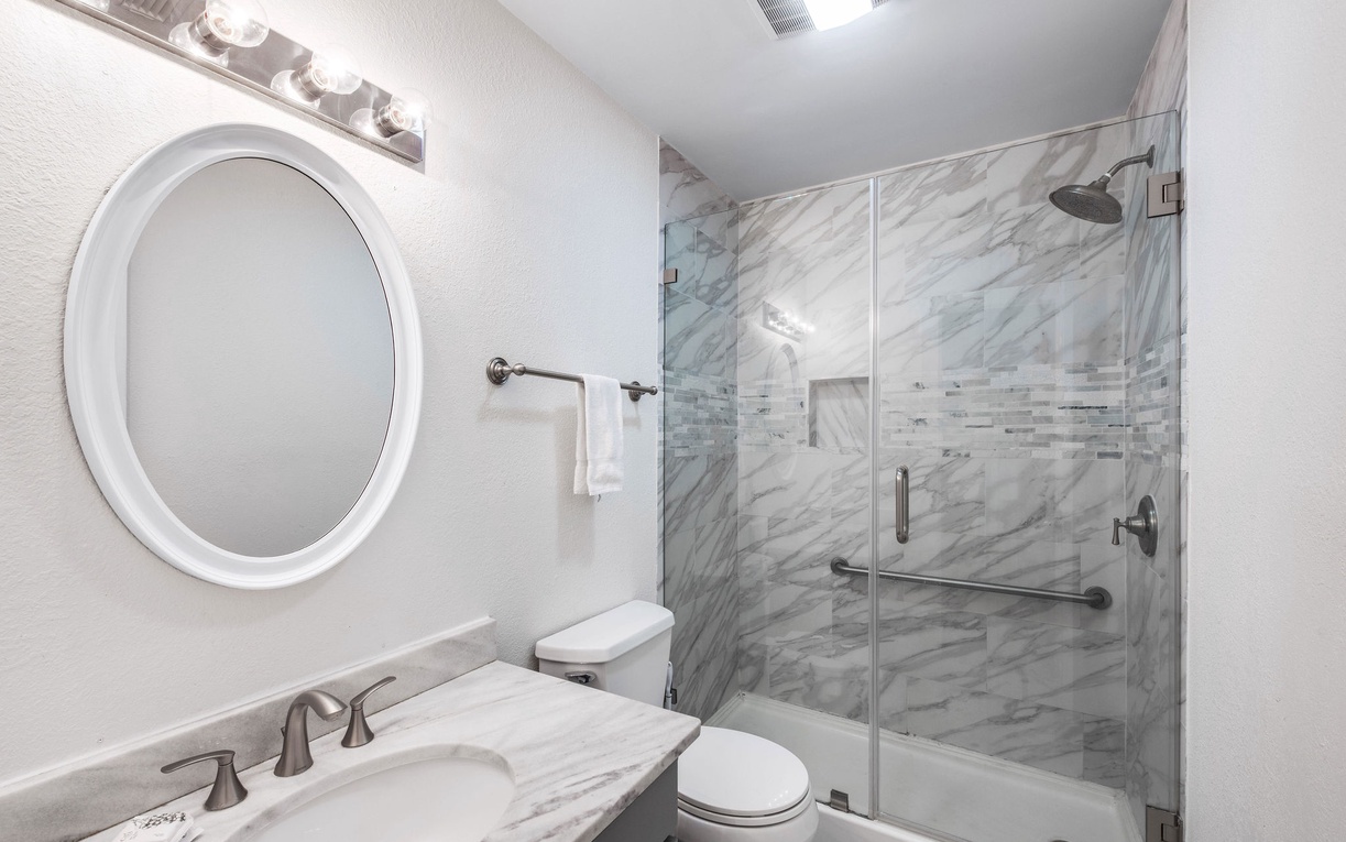 Step into your marble-inspired spa sanctuary with elegant walk-in shower and polished finishes for ultimate relaxation.