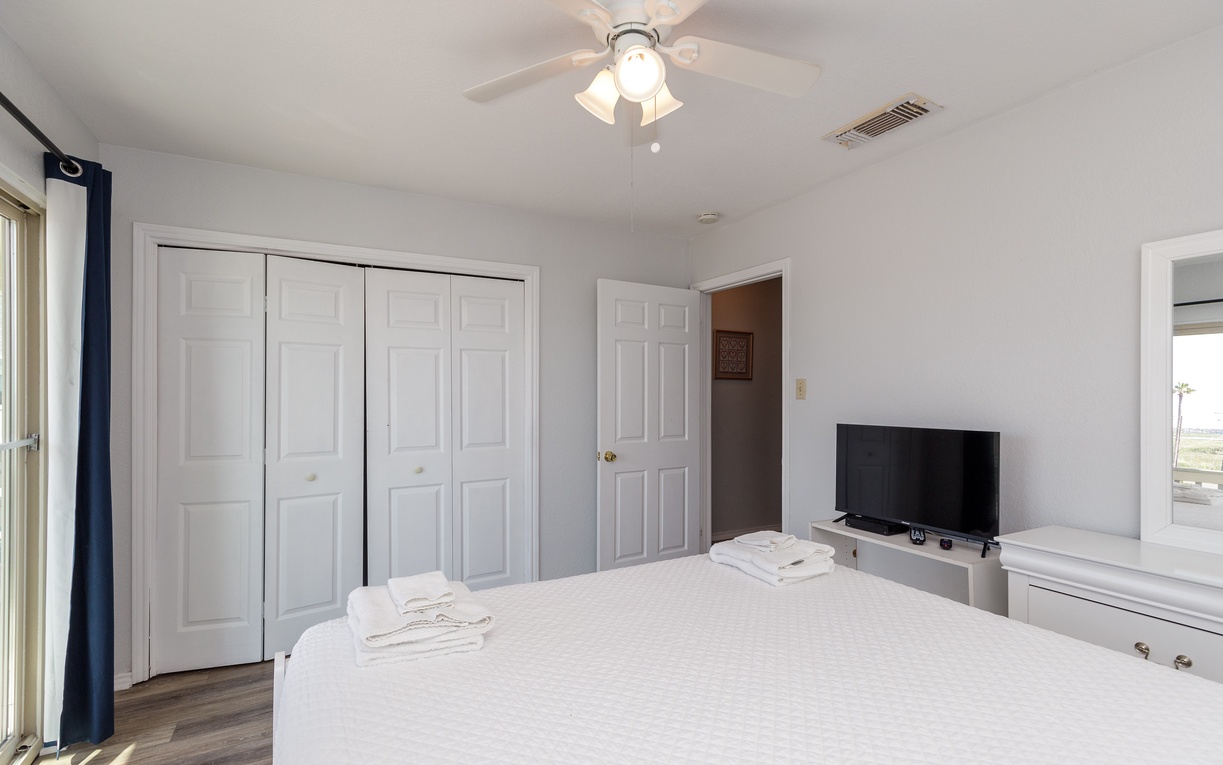 Your spacious bedroom offers comfort with a ceiling fan, TV for entertainment, and ample closet storage for all your belongings.