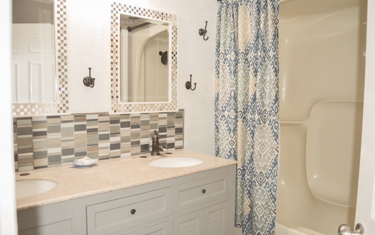 Step into your beautifully designed bathroom with elegant tile work, dual vanities, and a relaxing tub-shower combo for your comfort.