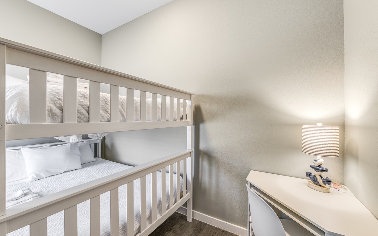 Cozy bunk bed setup with desk space for work or play in your comfortable retreat.