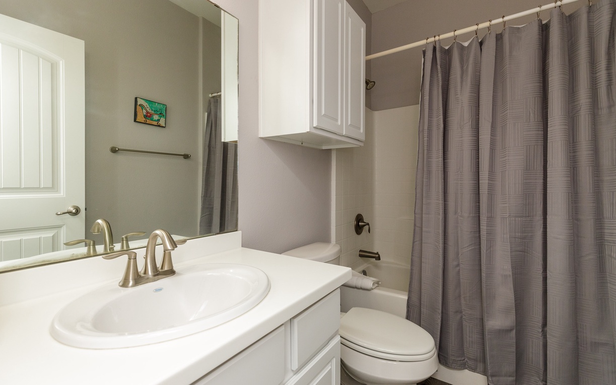 Freshen up in your private bathroom featuring clean white fixtures and modern amenities for your comfort.