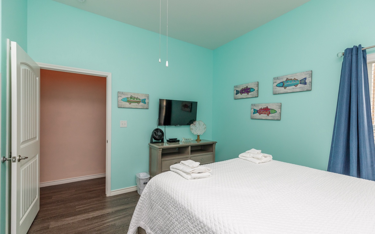 Drift off in your serene aqua retreat, where coastal-themed art and crisp linens create the perfect seaside sanctuary.