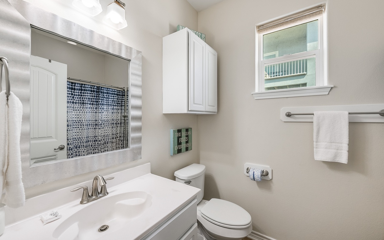 Your private bathroom features crisp white fixtures and beautiful mosaic tile accents that catch the morning light perfectly.