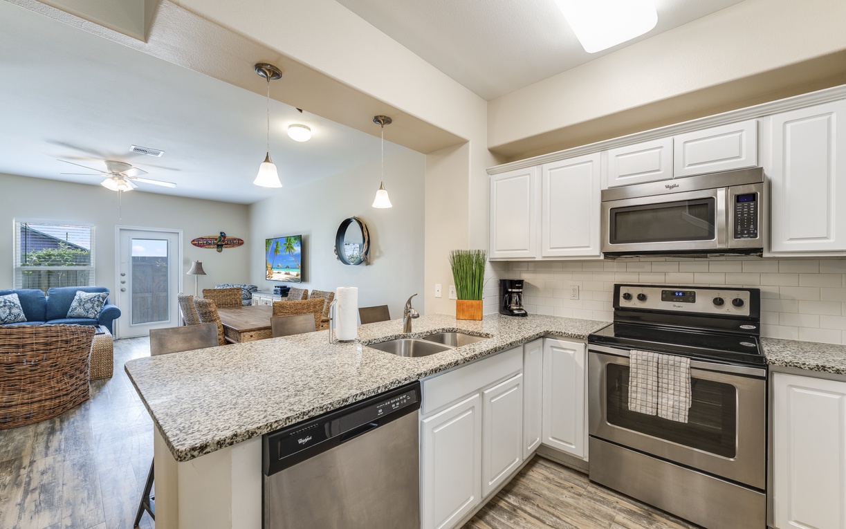Your modern kitchen invites culinary adventures with granite countertops, stainless steel appliances, and an open layout flowing seamlessly into your dining and living spaces.