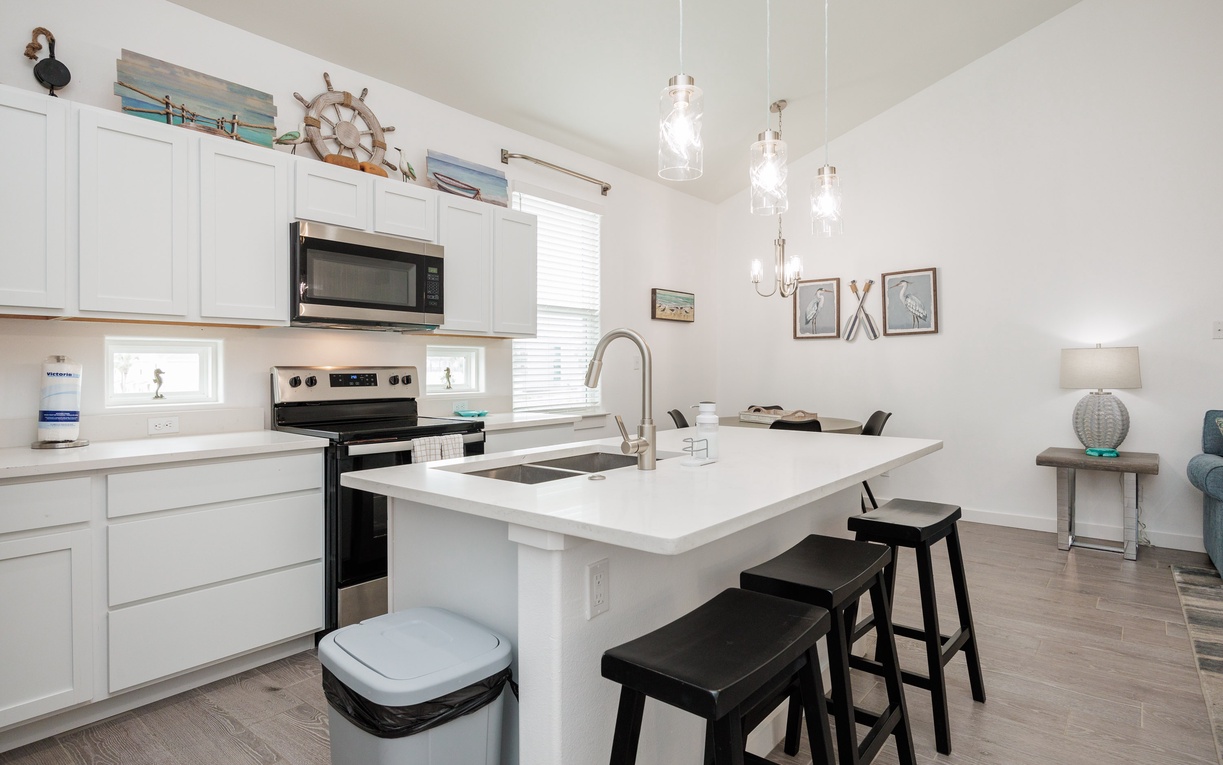 Your bright, coastal-themed kitchen invites you to cook with nautical charm and modern convenience at your fingertips.
