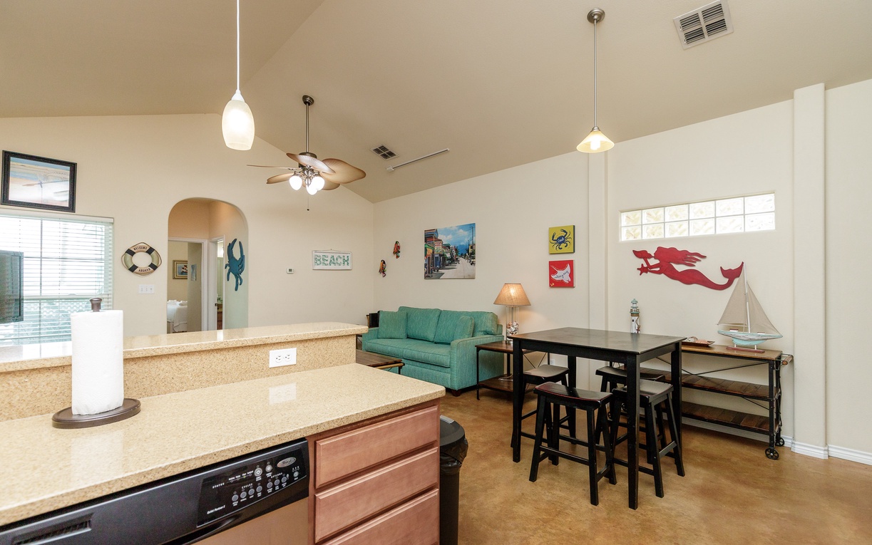 Step into your coastal-themed open living space where nautical charm meets modern comfort, perfect for gathering around the dining table.